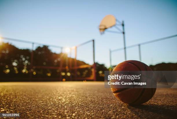 close-up of basketball on ground in court during sunset - basketball close up ストックフォトと画像
