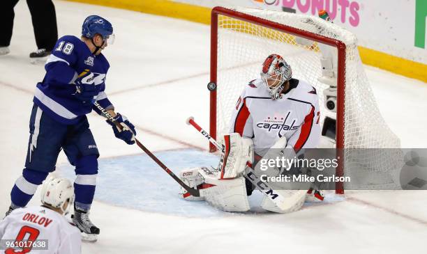 Braden Holtby of the Washington Capitals makes a save against Ondrej Palat of the Tampa Bay Lightning during the first period in Game Five of the...