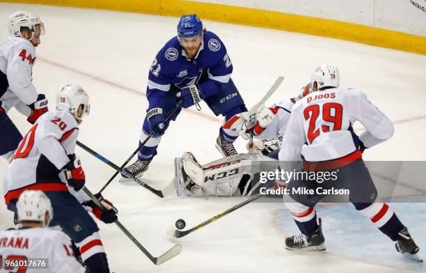 Brayden Point of the Tampa Bay Lightning looks for a rebound between goalie Braden Holtby and Christian Djoos of the Washington Capitals during the...