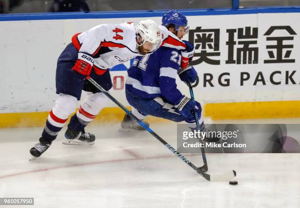 Brooks Orpik of the Washington Capitals checks Brayden Point of the Tampa Bay Lightning during the third period in Game Five of the Eastern...