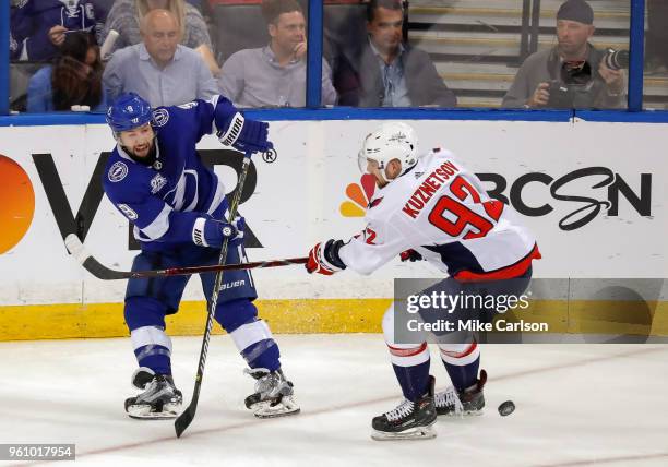 Tyler Johnson of the Tampa Bay Lightning moves the puck past Evgeny Kuznetsov of the Washington Capitals during the third period in Game Five of the...