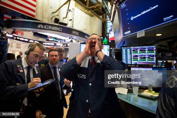 Traders work on the floor of the New York Stock Exchange in New York, U.S., on Monday, May 21, 2018. U.S. Stocks surged and the dollar strengthened...