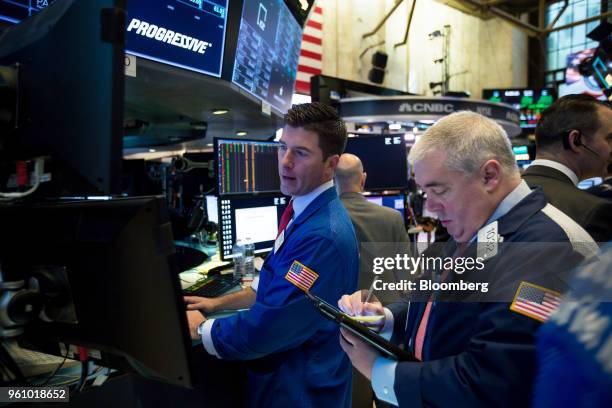 Traders work on the floor of the New York Stock Exchange in New York, U.S., on Monday, May 21, 2018. U.S. Stocks surged and the dollar strengthened...