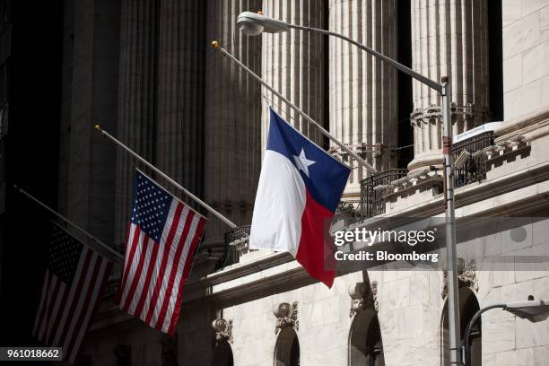 Texas flag hangs half-staff in front of the New York Stock Exchange in New York, U.S., on Monday, May 21, 2018. U.S. Stocks surged and the dollar...