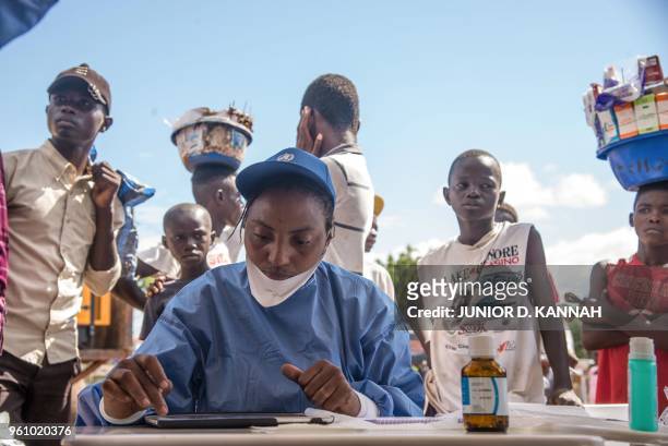 Nurses working with the World Health Organization prepare to administer vaccines at the town all of Mbandaka on May 21, 2018 during the launch of the...
