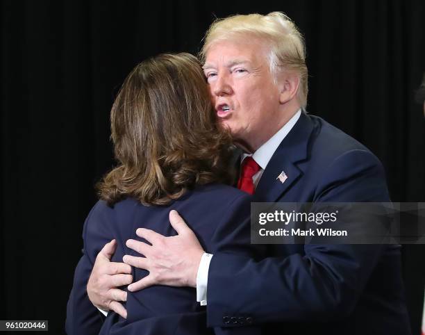 President Donald Trump hugs Gina Haspel after she was sworn in as CIA director during a swearing-in ceremony at agency headquarters, May 21, 2018 in...