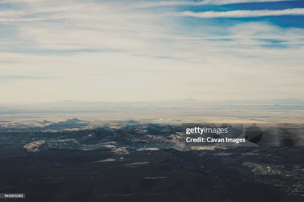 Scenic view of landscape against cloudy sky