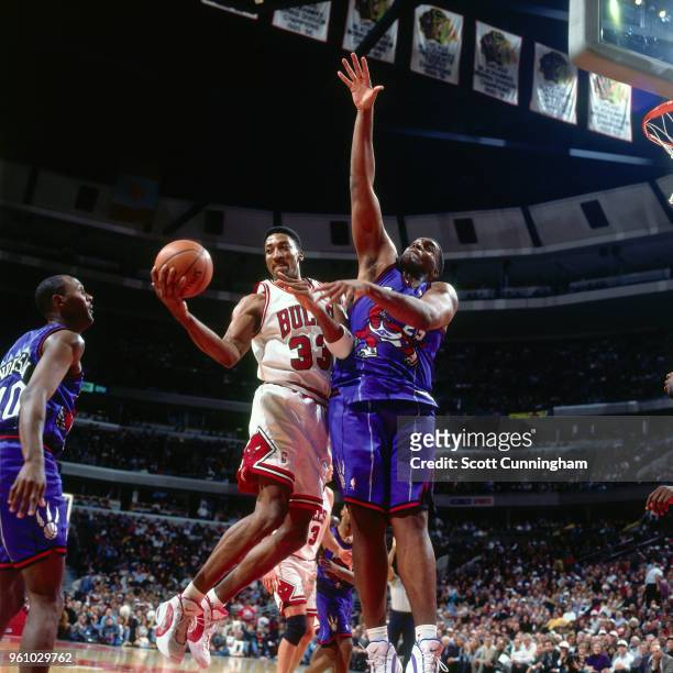Scottie Pippen of the Chicago Bulls goes to the basket against Oliver Miller of the Toronto Raptors on November 7, 1995 at the United Center in...