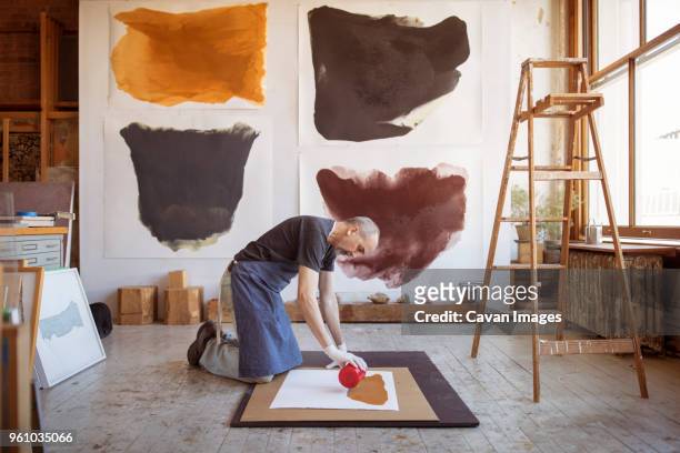 full length of male artist making painting in workshop - bent ladder stock pictures, royalty-free photos & images