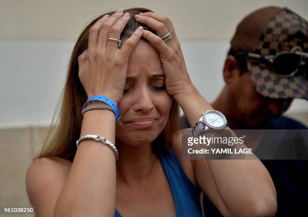 Relative of 19-year-old Mailen Diaz Almaguer, one of the survivors of the plane crash, cries after receiving a medical report at the Calixto Garcia...