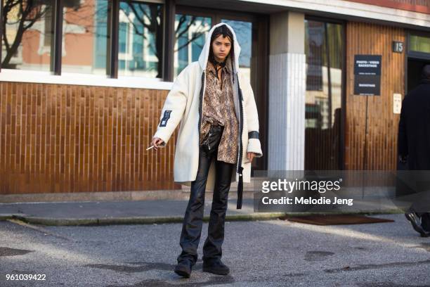 Model Fernanda Oliveira wears a white Director Bee shearling hooded jacket, a snakeskin shirt, black leather pants, and black shoes during Milan...