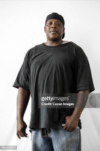 portrait of manual worker standing against white background - chubby men stock pictures, royalty-free photos & images