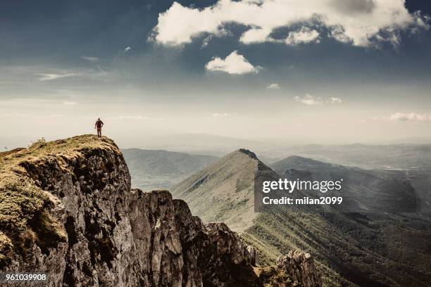 man on top of a mountain - summit milan stock pictures, royalty-free photos & images