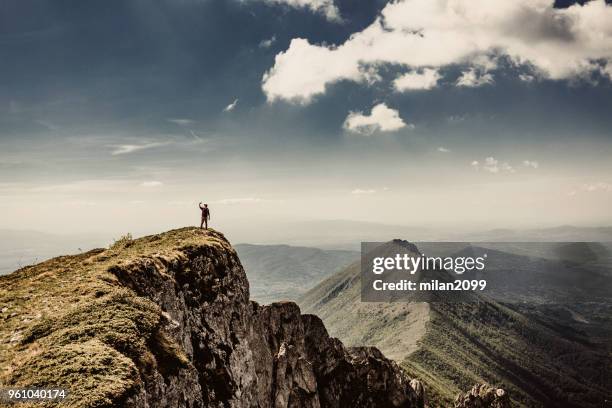 man on top of a mountain - summit milan stock pictures, royalty-free photos & images