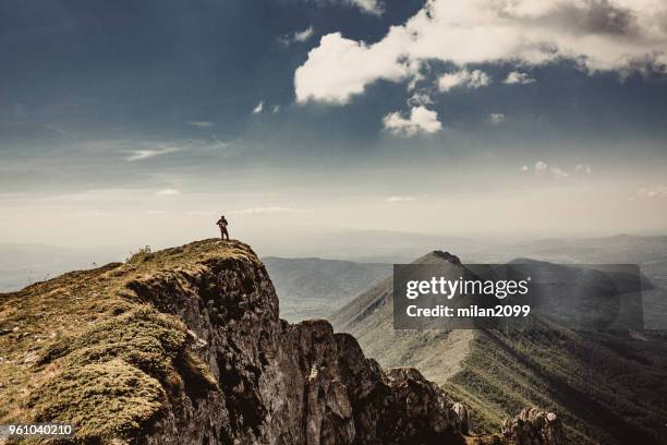 man on top of a mountain - summit milan stock pictures, royalty-free photos & images