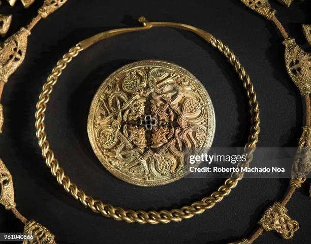 Set of golden jewels. Objects from the Vikings era over a black background. Exhibit at the Royal Ontario Museum .