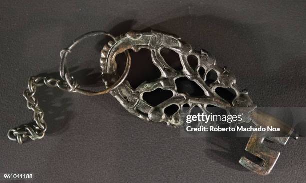Antique metallic key. Objects from the Vikings era over a black background. Exhibit at the Royal Ontario Museum .