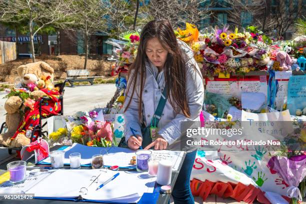 Toronto Van Attack a week later: Woman signing the condolences book at the memorial site .Image taken at Olive Park in the intersection of Finch...