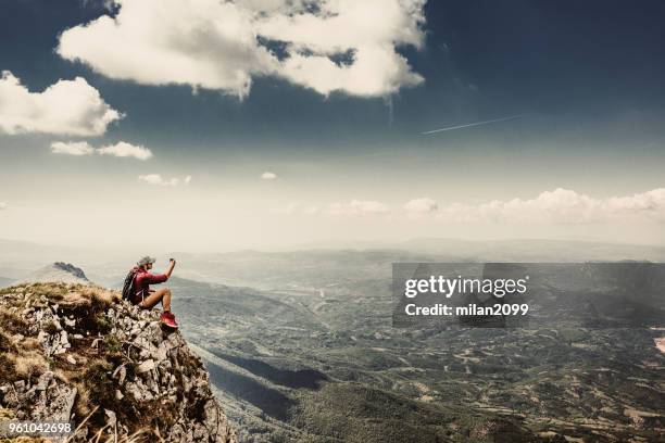 man on top of a mountain - summit milan stock pictures, royalty-free photos & images