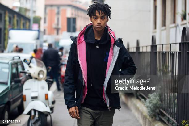 Model Tristan Cole wears a black jacket with a pink hoodie during Milan Men's Fashion Week Fall/Winter 2018/19 on January 15, 2018 in Milan, Italy.
