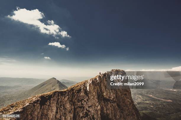 man on top of a mountain - summit milan stock pictures, royalty-free photos & images