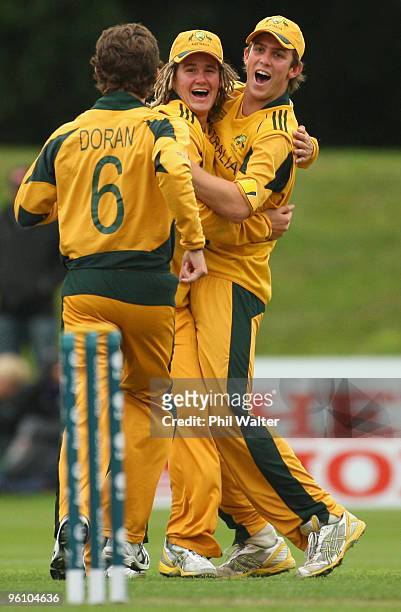 Tom Beaton of Australia celebrates catching out Craig Cachopa of New Zealand with Mitchell Marsh as bowler Luke Doran runs in during the ICC U19...