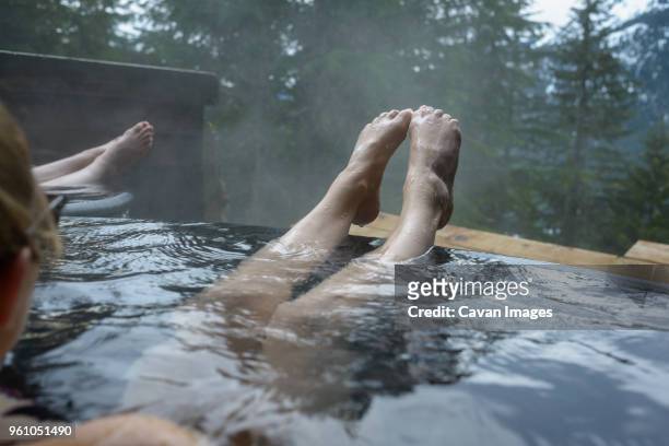 cropped image of woman in hot spring - hot tub stock pictures, royalty-free photos & images