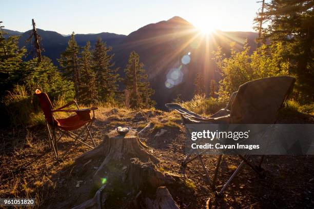 folding chairs on field against mountain during sunset - folding chair stock pictures, royalty-free photos & images
