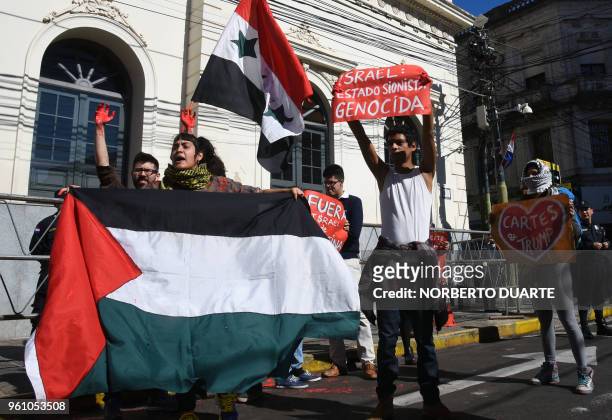 Activists with Palestinian flags, demonstrate outside the Paraguayan Foreign Minister in Asuncion, to protest against the inauguration of the...