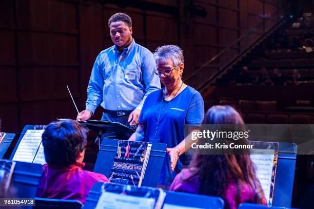 National Association of Music Merchant volunteer Marcia Neel speaks with students during the NAMM Day Of Service With DC Public Schools Music...