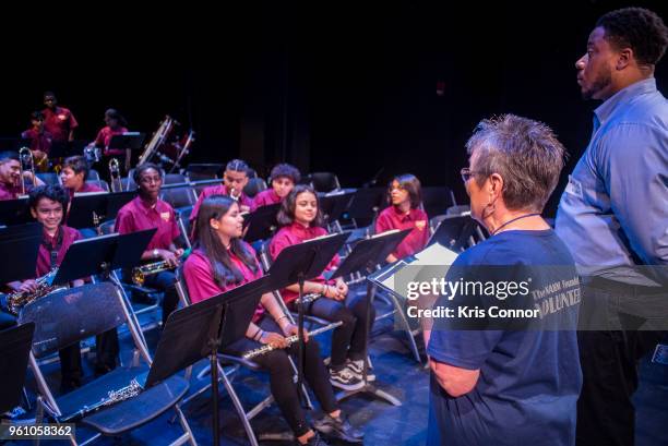 National Association of Music Merchant volunteer Marcia Neel speaks with students during the NAMM Day Of Service With DC Public Schools Music...