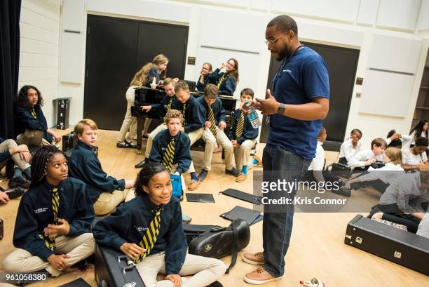 National Association of Music Merchant volunteers help students during the NAMM Day Of Service With DC Public Schools Music Festival At The Kennedy...