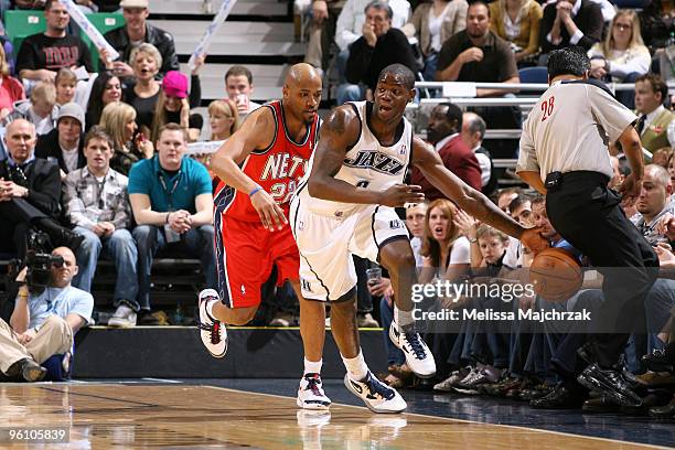 Ronnie Brewer of the Utah Jazz tries to save the ball from going out of bounds against Jarvis Hayes of the New Jersey Nets at EnergySolutions Arena...