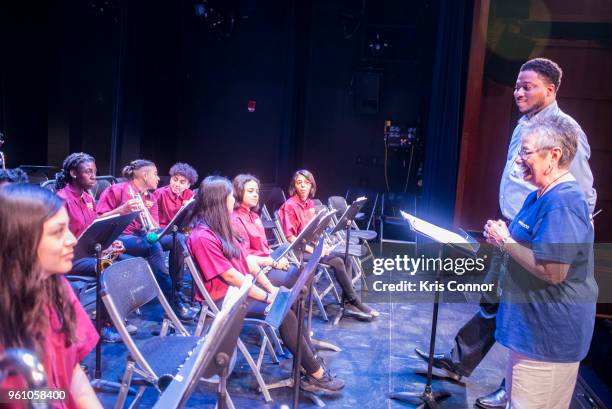 National Association of Music Merchant volunteer Marcia Neel speaks with students during the NAMM Day Of Service With DC Public Schools Music...