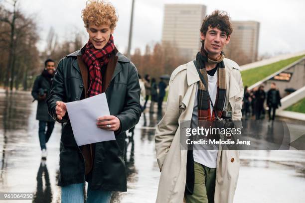 Robbi G and Nick Offord exit a show during Paris Fashion Week Menswear Fall/Winter 2018 on January 18, 2018 in Paris, France. Robbi wears a black...