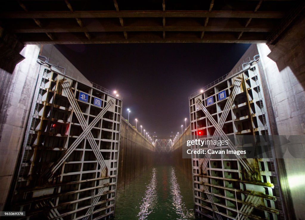 Open canal lock against clear sky at night