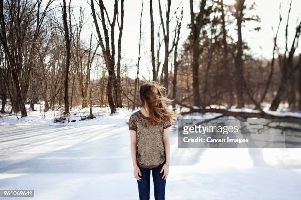 woman with windswept hair standing on snowcapped landscape - somerville - fotografias e filmes do acervo