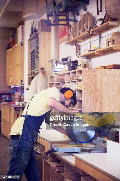 manual worker using circular saw at wood shop - tool rack stock pictures, royalty-free photos & images