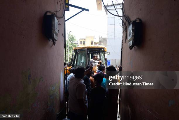 Municipal Corporation of Delhi officials demolish encroachments during an anti-encroachment drive at Nizamuddin Railway Station on May 21, 2018 in...