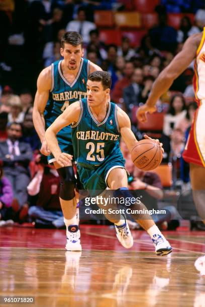 Tony Bennett of the Charlotte Hornets handles the ball handles the ball against the Atlanta Hawks on March 23, 1994 at the Omni Coliseum in Atlanta,...