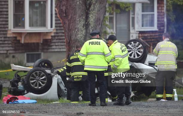 Police and fire officials investigate a fatal single car crash in East Bridgewater, MA on May 19, 2018. Four male teenagers were killed and a fifth...