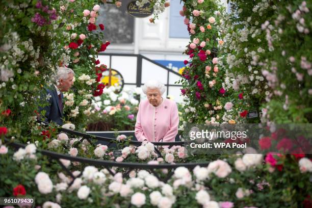 Queen Elizabeth II looks at a display of roses on the Peter Beale roses display at the Chelsea Flower Show 2018 on May 21, 2018 in London, England.