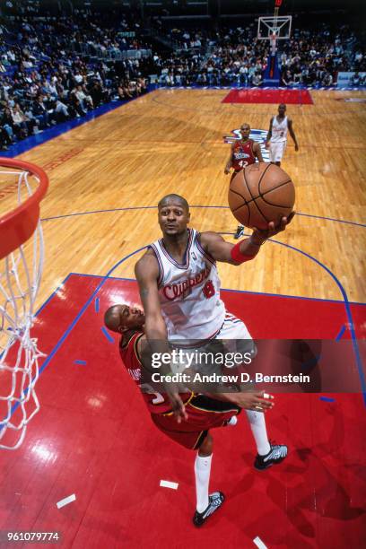 Tyrone Nesby of the LA Clippers shoots the ball against Jerome Williams of the Detroit Pistons circa 1999 at the Staples Center in Los Angeles,...
