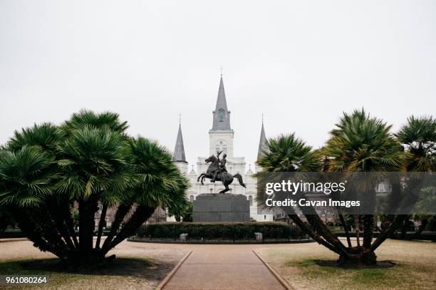 andrew jackson statue and st. louis cathedral against clear sky - st louis cathedral new orleans stock pictures, royalty-free photos & images