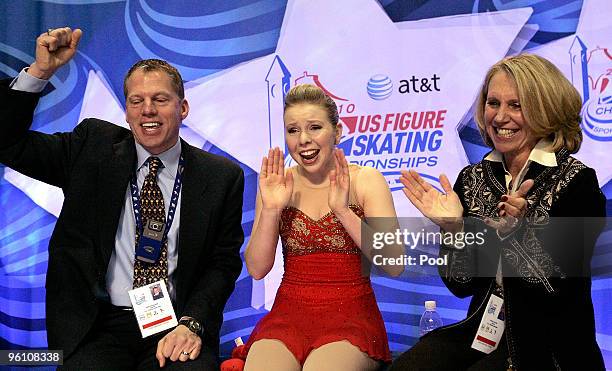 Rachael Flatt celebrates with her coaches Tom Zakrajsek and Becky Collins after seeing her scores to finish first to win the gold medal at the US...