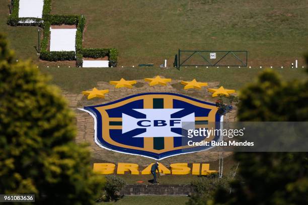 Workers clean a logo of the Brazilian Football Confederation at Granja Comary Training Centre, where the Brazilian football team is hosted for the...