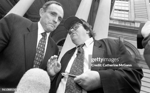 American filmmaker Michael Moore, right, and New York City Mayor Rudolph Giuliani outside City Hall, during taping of an episode of Moore's NBC...