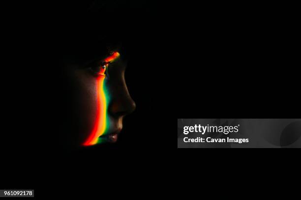 close-up of spectrum on girl in darkroom - dark room foto e immagini stock