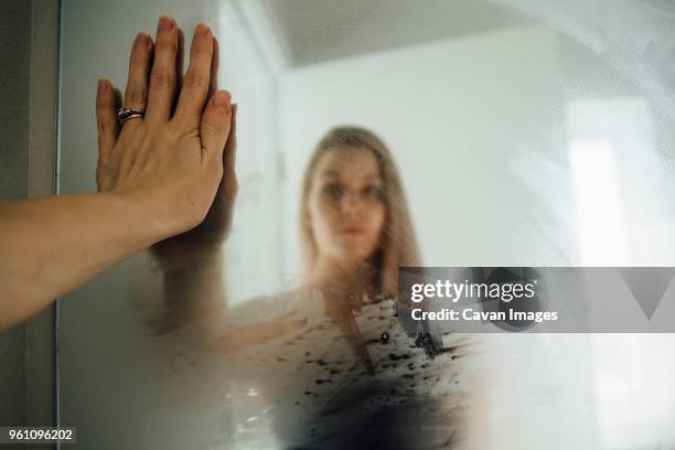 woman reflecting on wet mirror at home - steamy mirror stock pictures, royalty-free photos & images