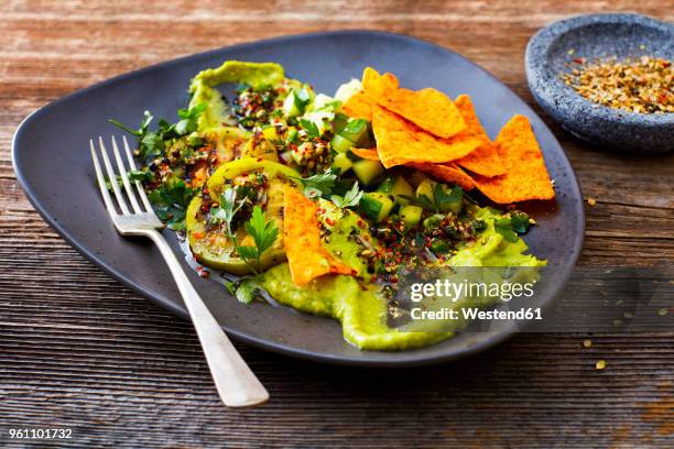 guacamole with grilled green tomatoes, cucumber and tortilla chips - slätpersilja bildbanksfoton och bilder